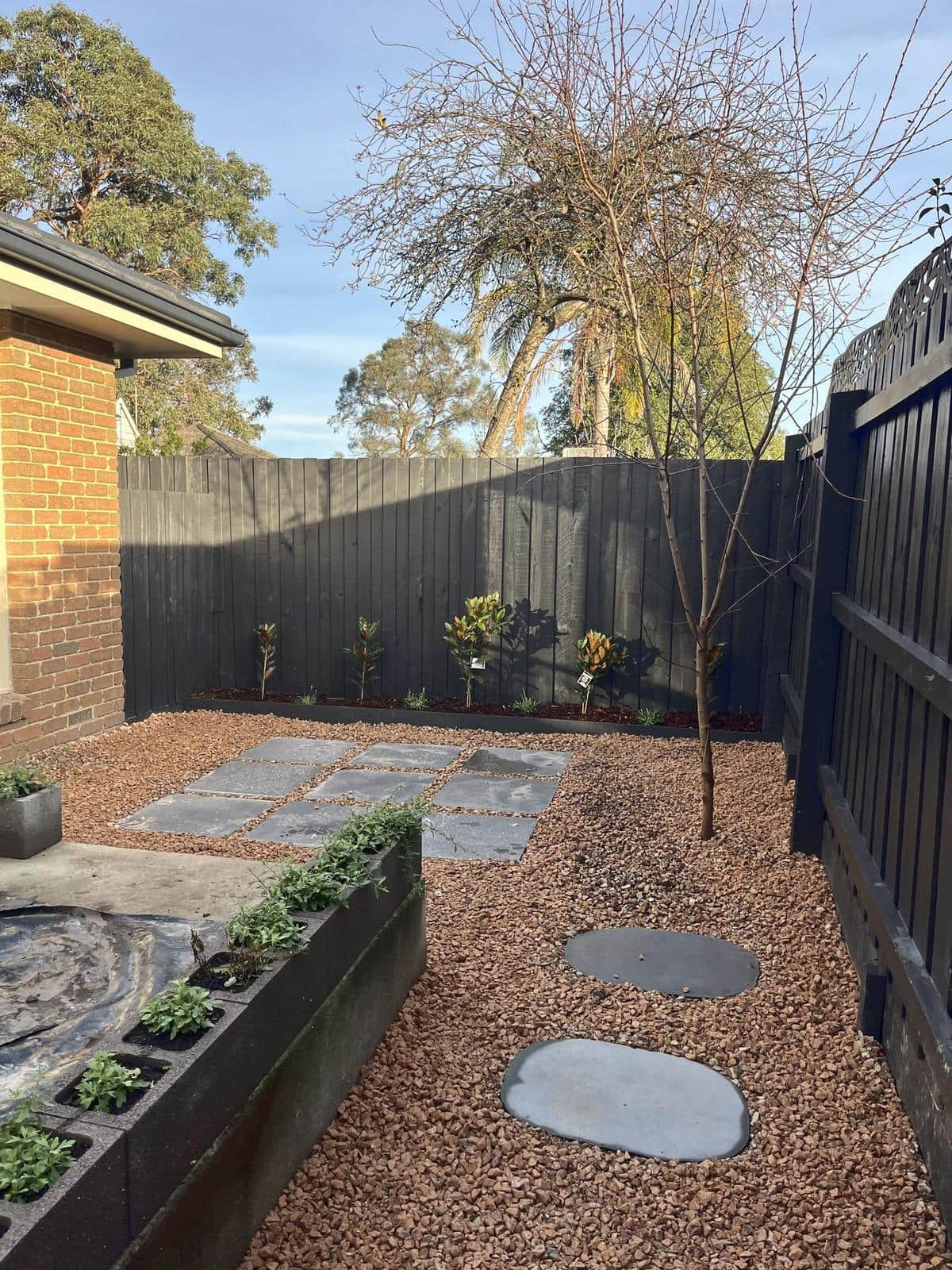 Gravel courtyard with stepping stones, pavers and a raised planter, Forest Hill