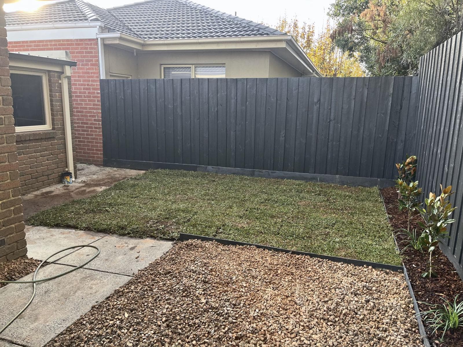Finished back garden with new turf, gravel and charcoal fence, Forest Hill